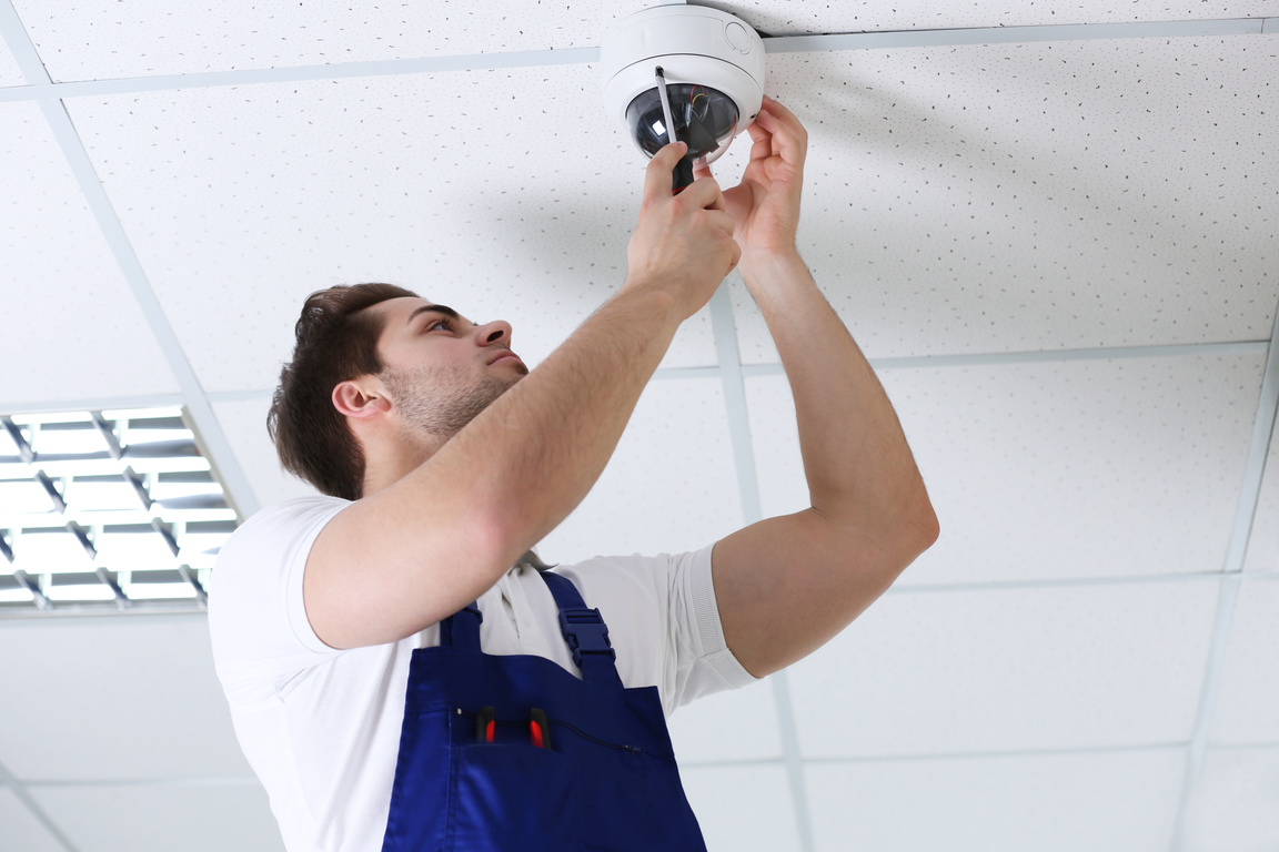Professional Technician Installing CCTV on Ceiling